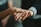 Close-up of hands in a supportive gesture during a therapy session.