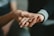 Close-up of hands offering support during a counseling session.