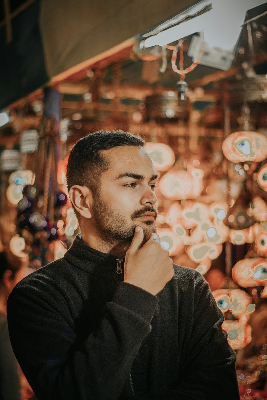 man in black sweater smoking cigarette