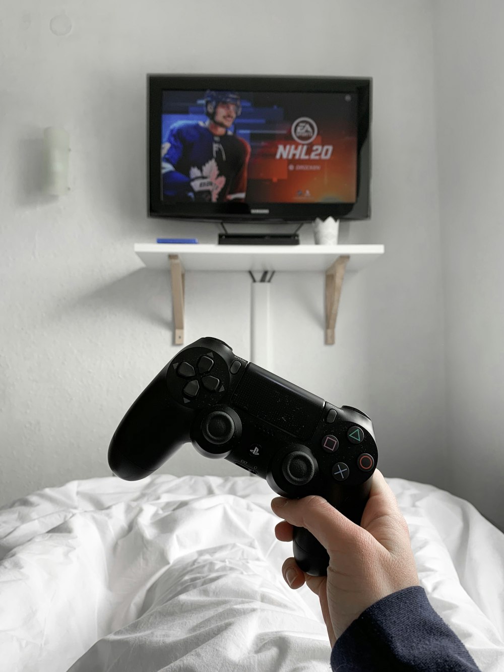 person holding black sony ps 4 controller