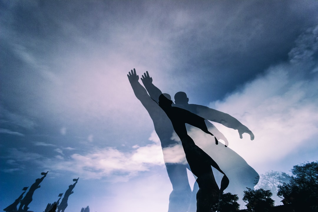 silhouette of 2 person jumping