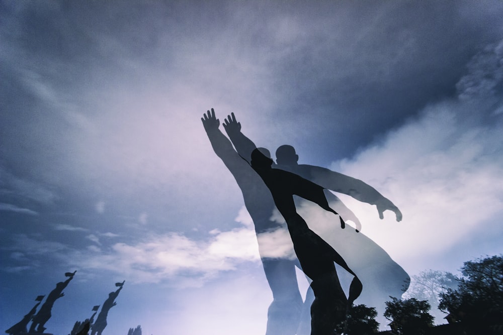 silhouette of 2 person jumping