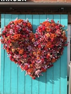 Close-up of a colorful, heart-shaped arrangement of fresh fruits and vegetables
