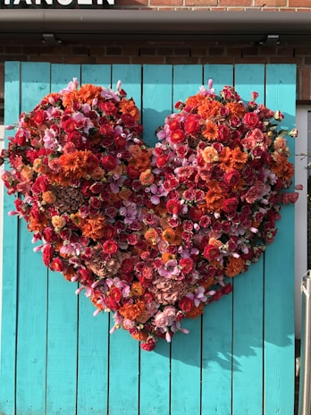 Close-up of heart-shaped flowers arranged beautifully on a beach backdrop.