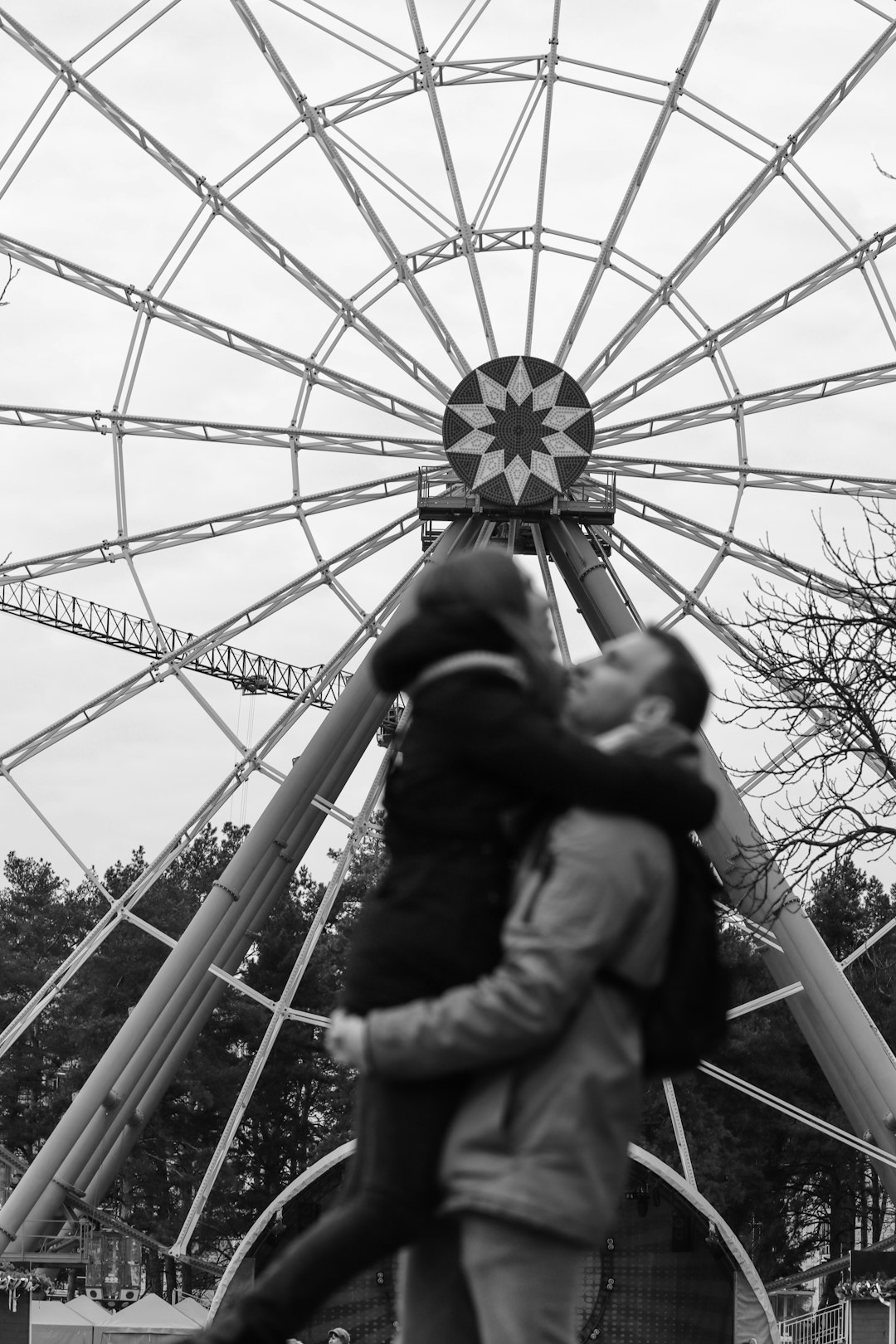 grayscale photo of man and woman kissing