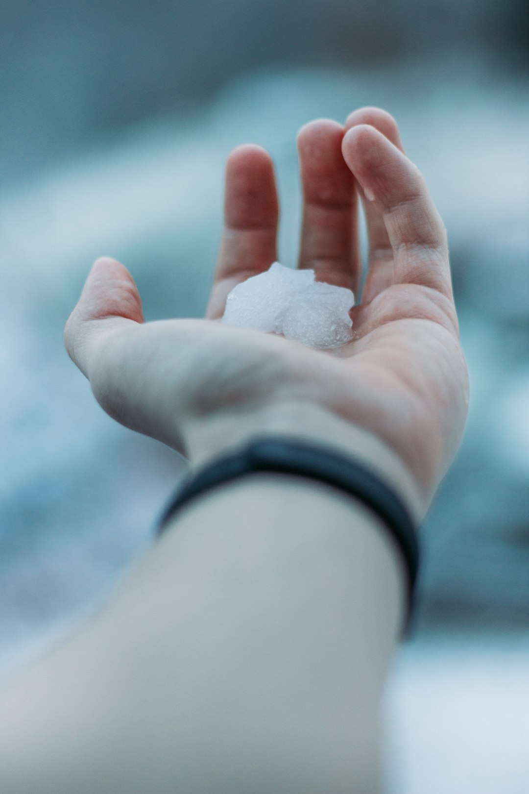 person holding white snow on hand