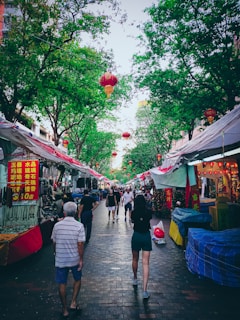 Volunteers handing out flyers and chatting with residents at a weekend market.