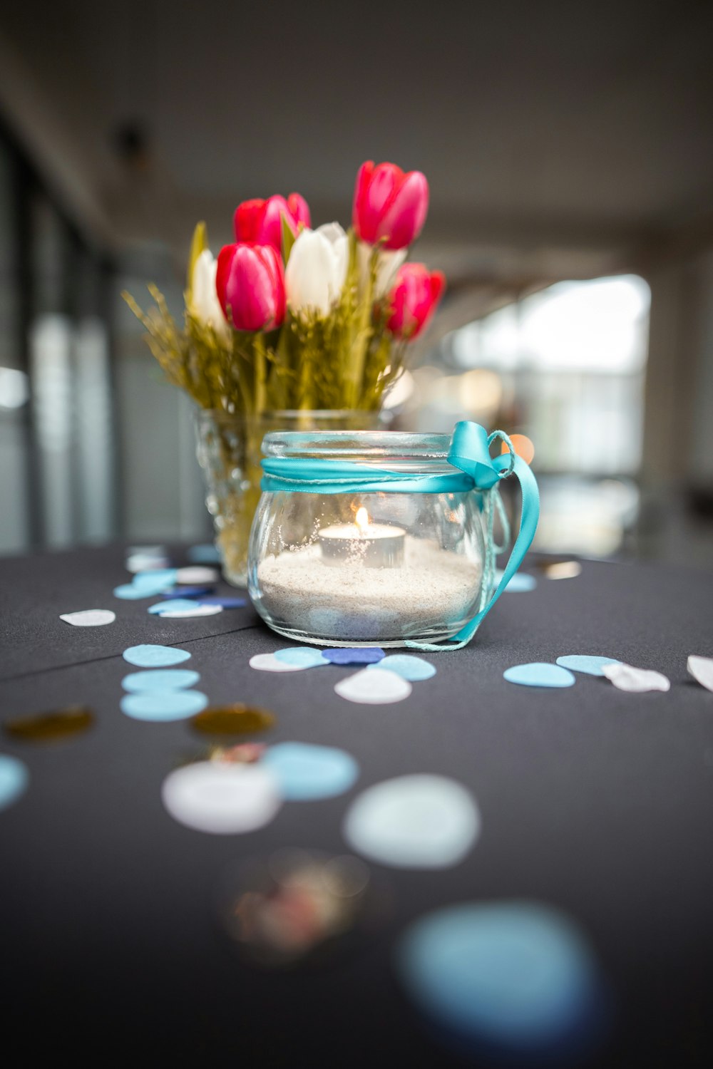 pink tulips in clear glass jar