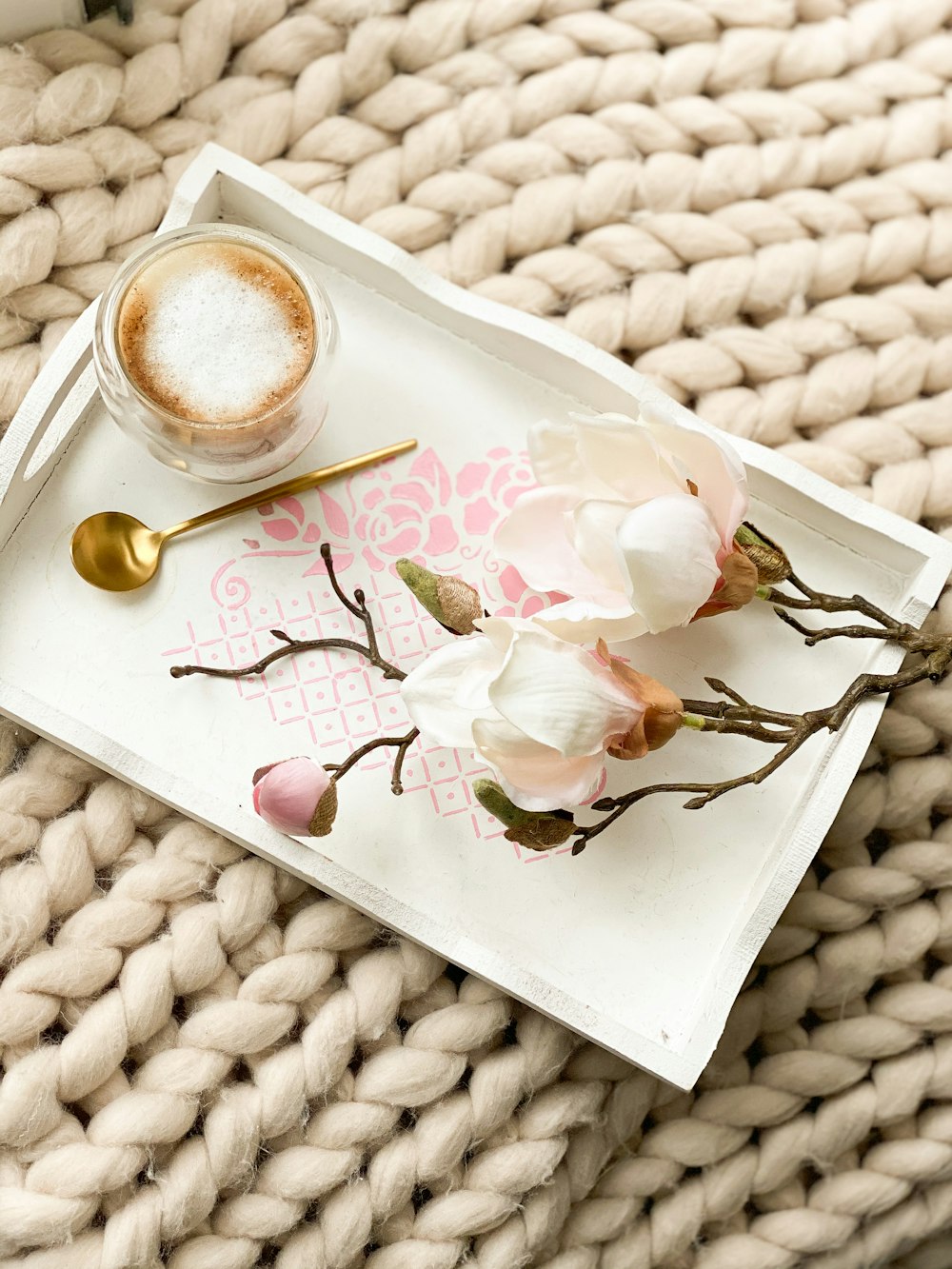 white ceramic teacup on white ceramic plate