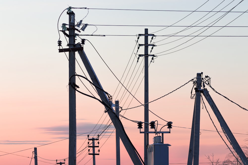 brown electric post under blue sky during daytime