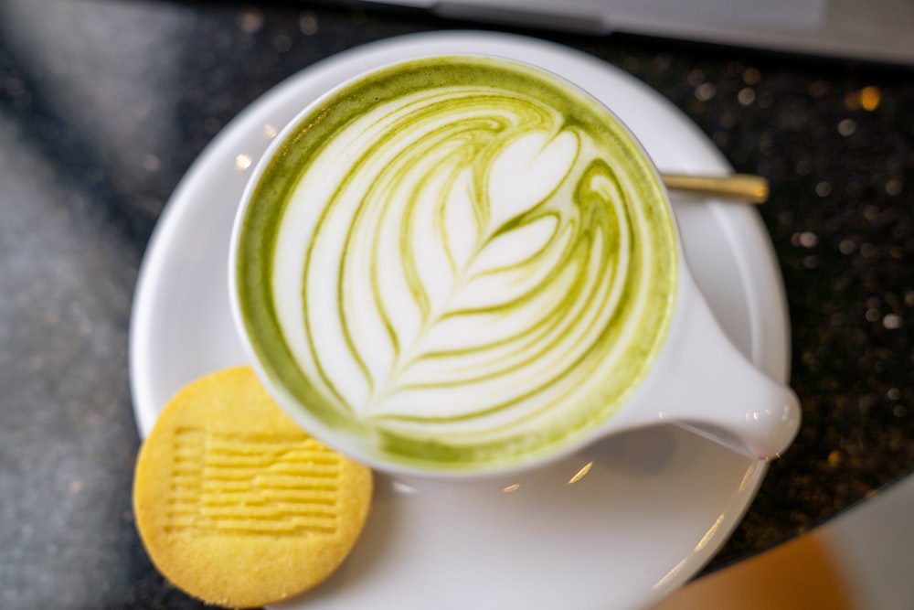 white ceramic mug with green and white liquid