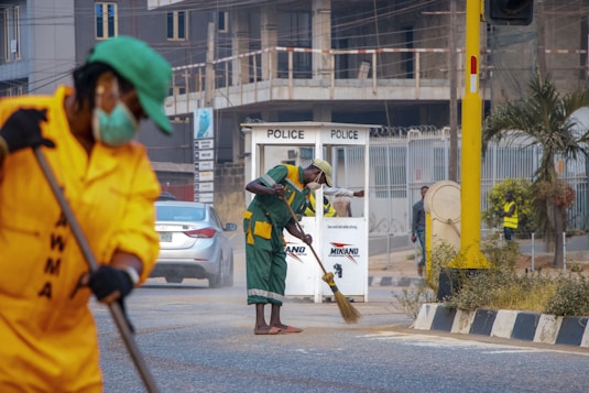woman in green coat holding brown stick