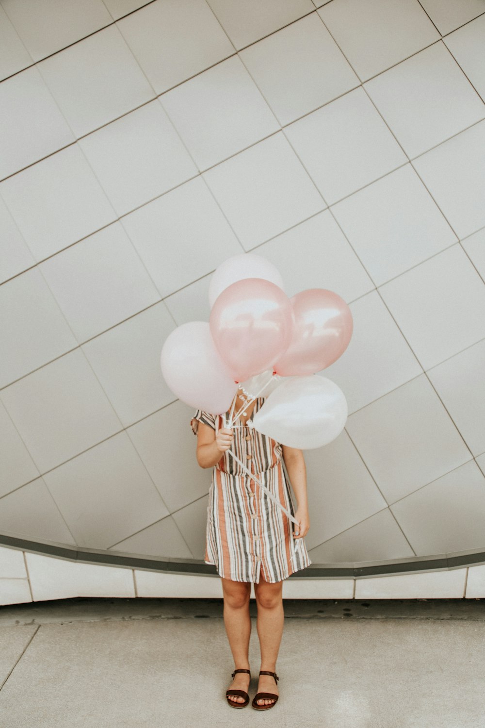 white and pink balloons on white ceramic tiles