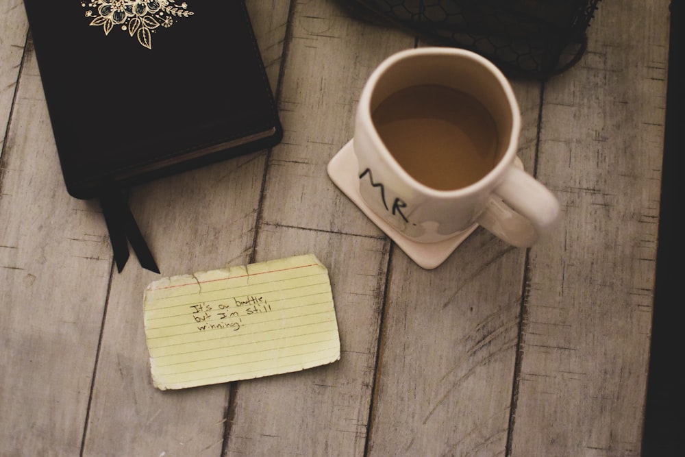 white ceramic mug with brown liquid