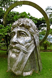 A large outdoor sculpture made of sustainable materials in a garden setting.
