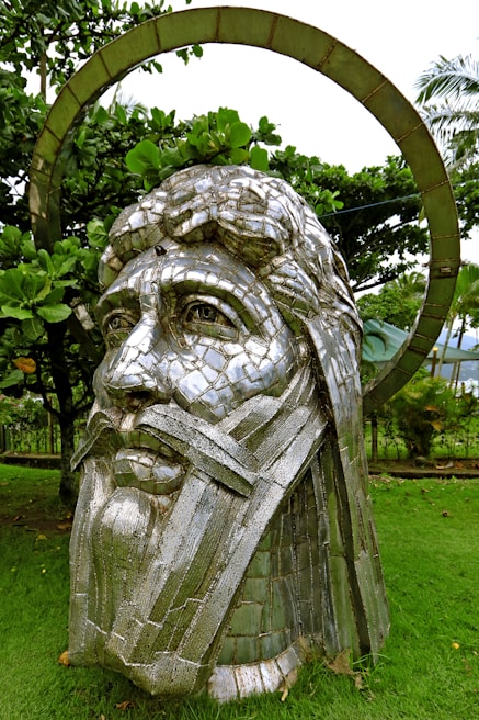 A large outdoor sculpture made of sustainable materials in a garden setting.