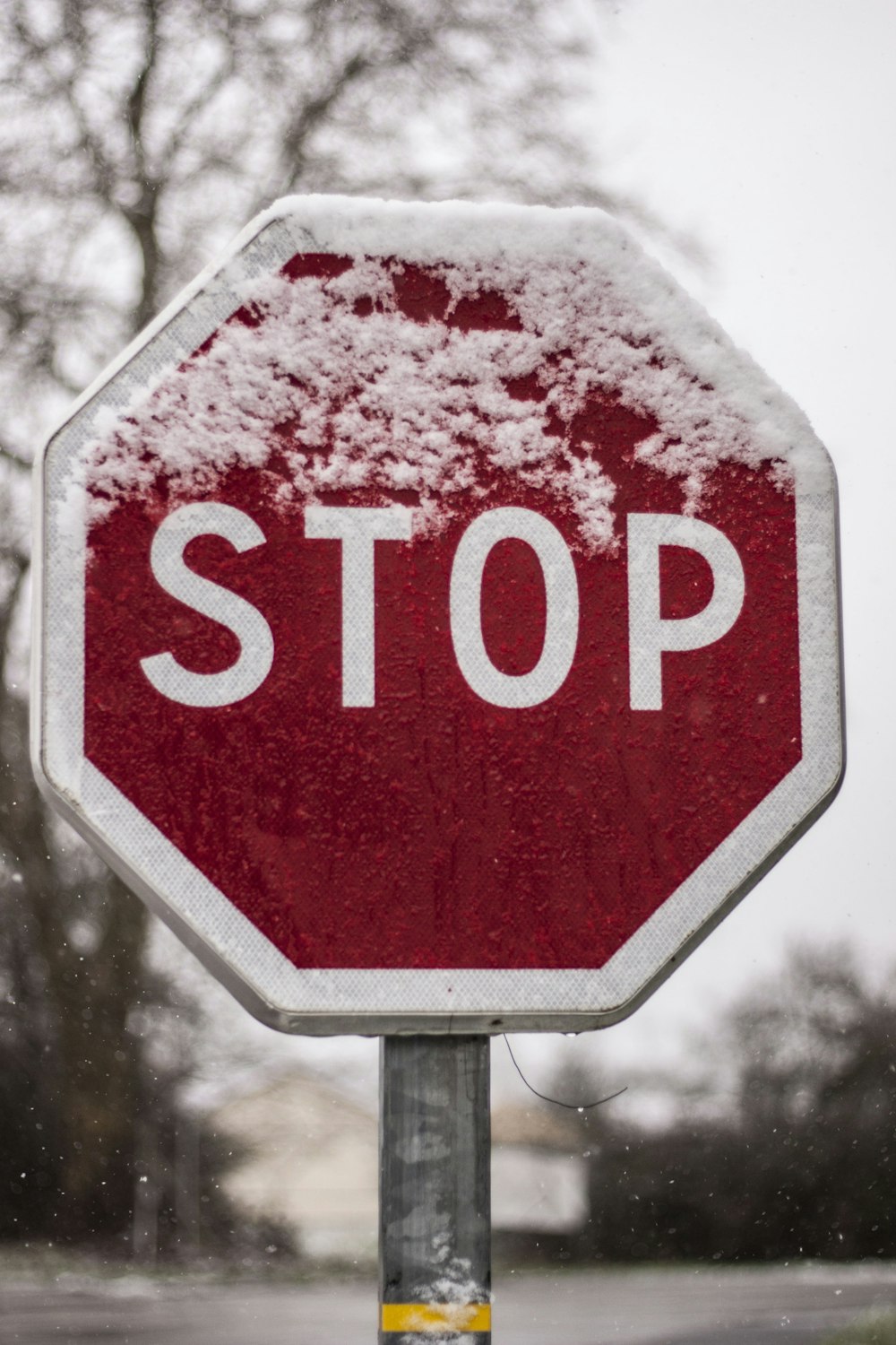 red stop sign with white snow