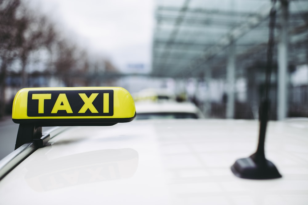 yellow and black taxi sign