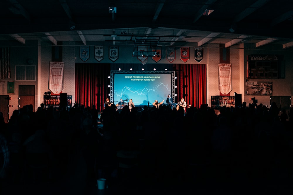 people standing on stage in front of crowd