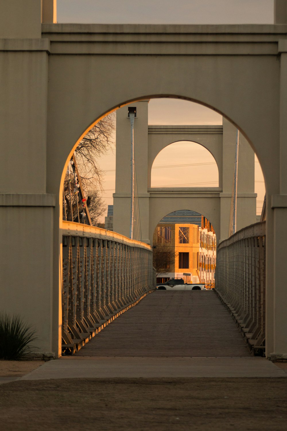 brown wooden bridge with white metal railings