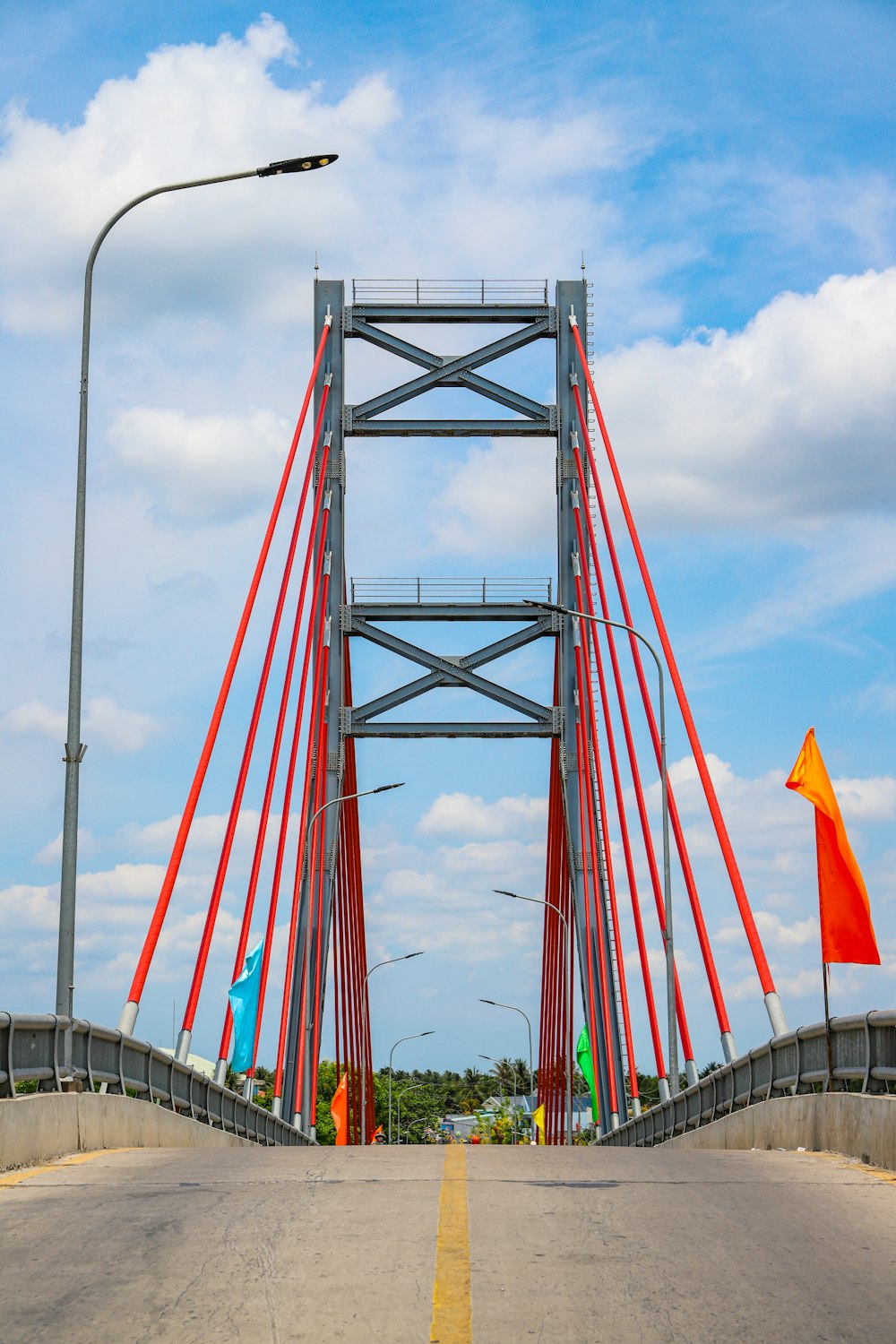 red and white bridge under cloudy sky during daytime