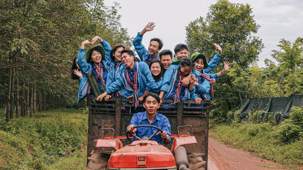 group of children riding red tractor