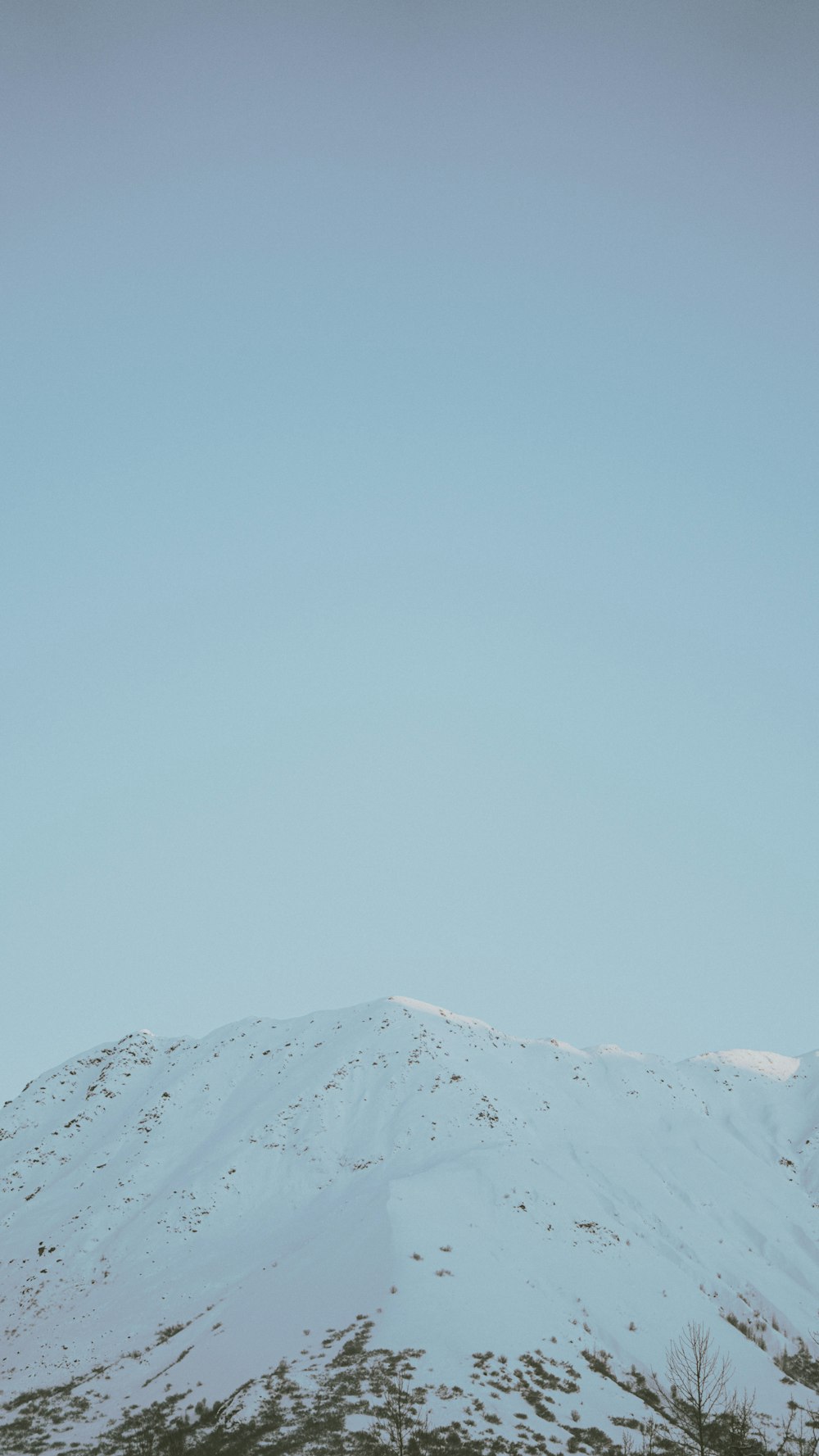 snow covered mountain under blue sky during daytime