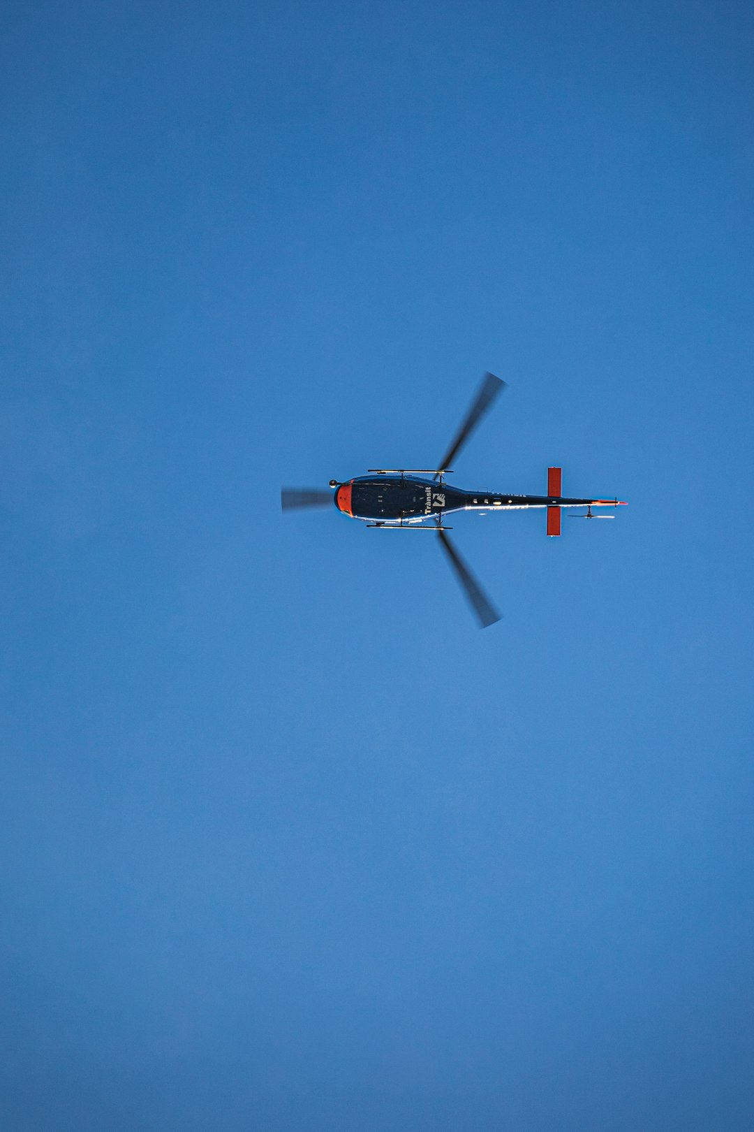 black and red plane flying in the sky