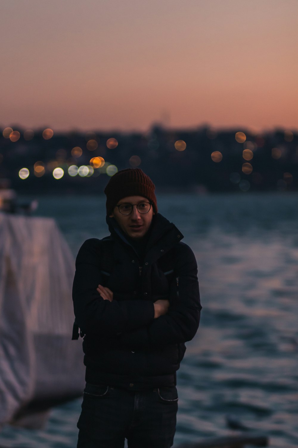 a man standing in front of a body of water