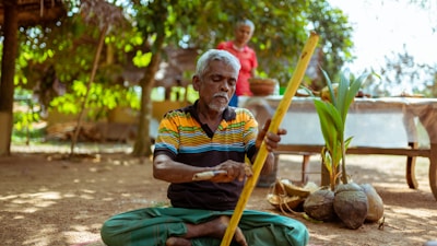 A specialist working patiently with a stroke survivor on coordination exercises in a peaceful home environment.