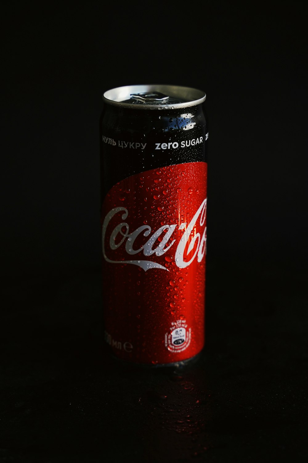 coca cola can on black surface