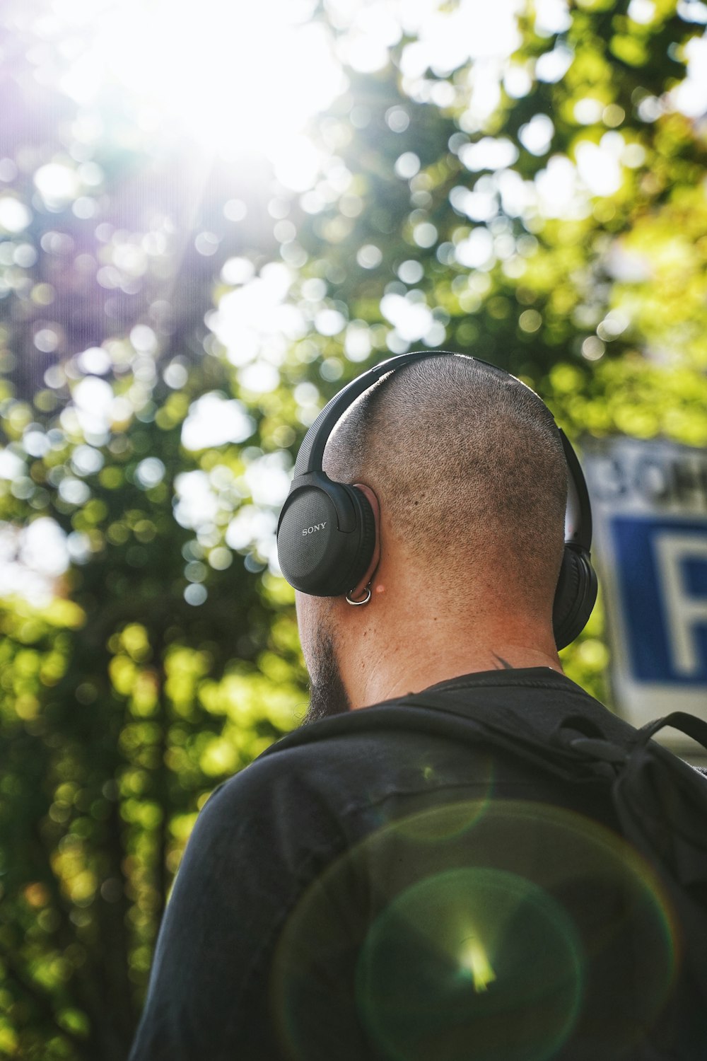 man in black and green camouflage jacket wearing black headphones