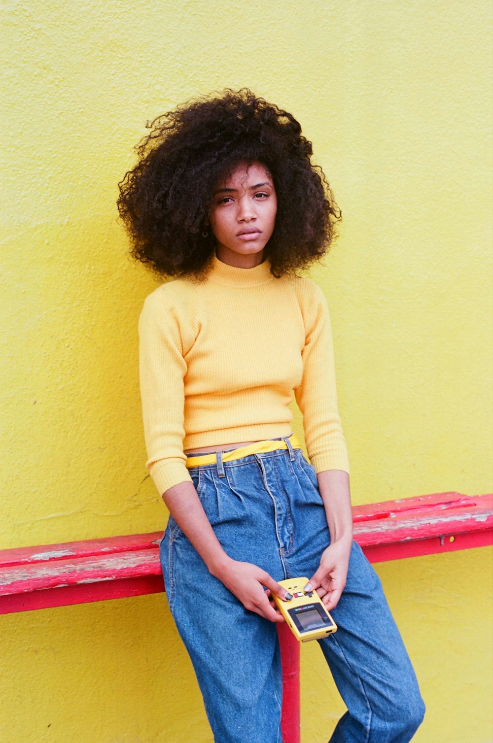 woman in yellow turtleneck sweater and blue denim jeans