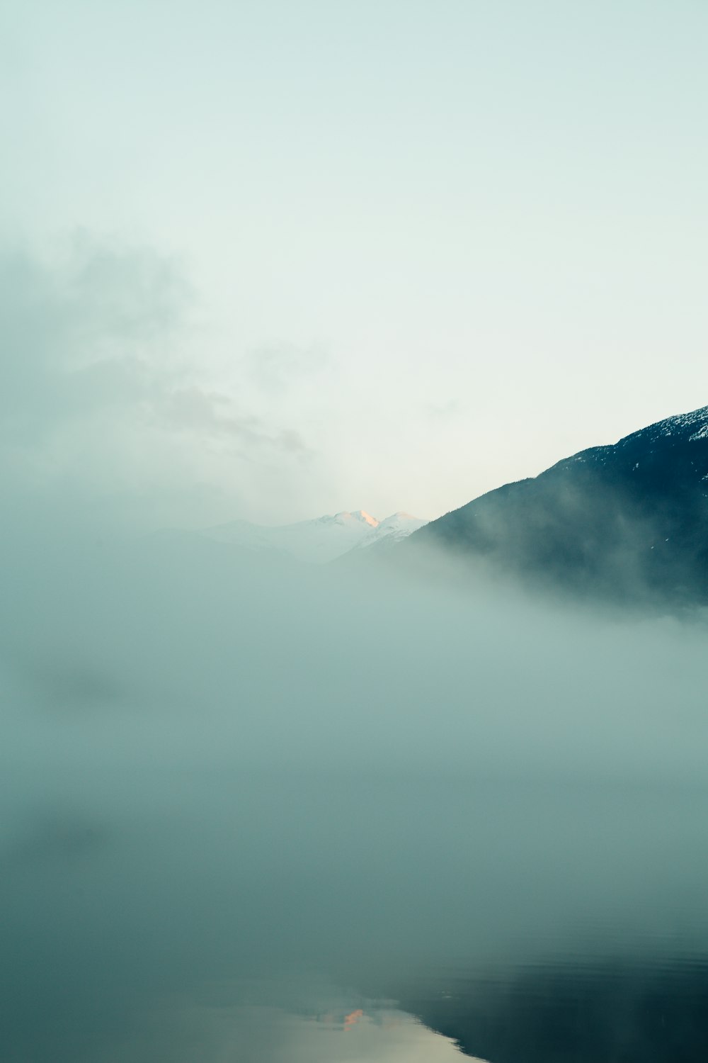 mountain covered with fog during daytime
