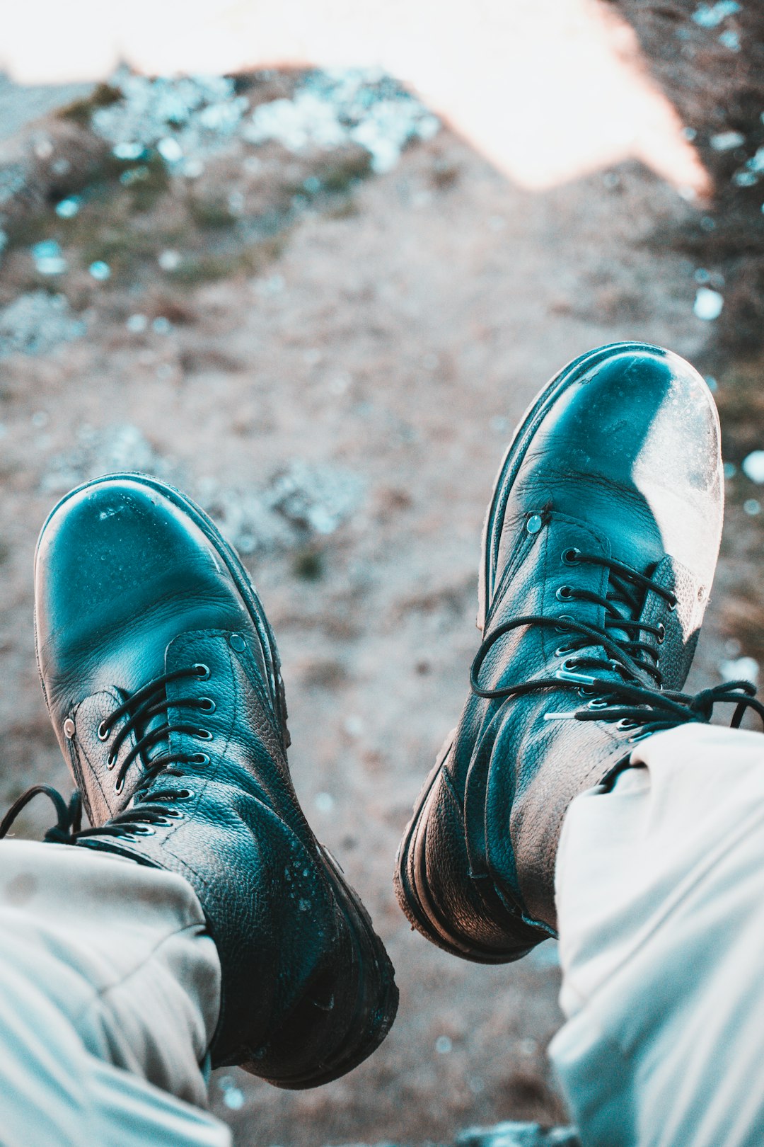 person wearing black leather lace up shoes