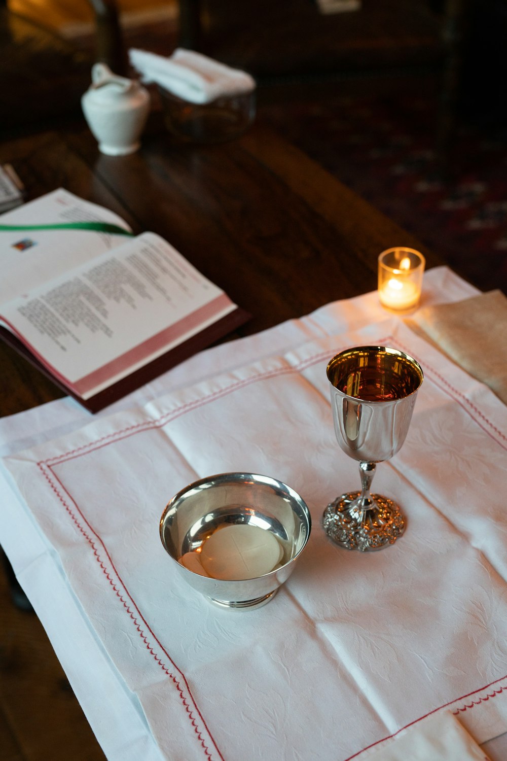 clear glass candle holder on white paper