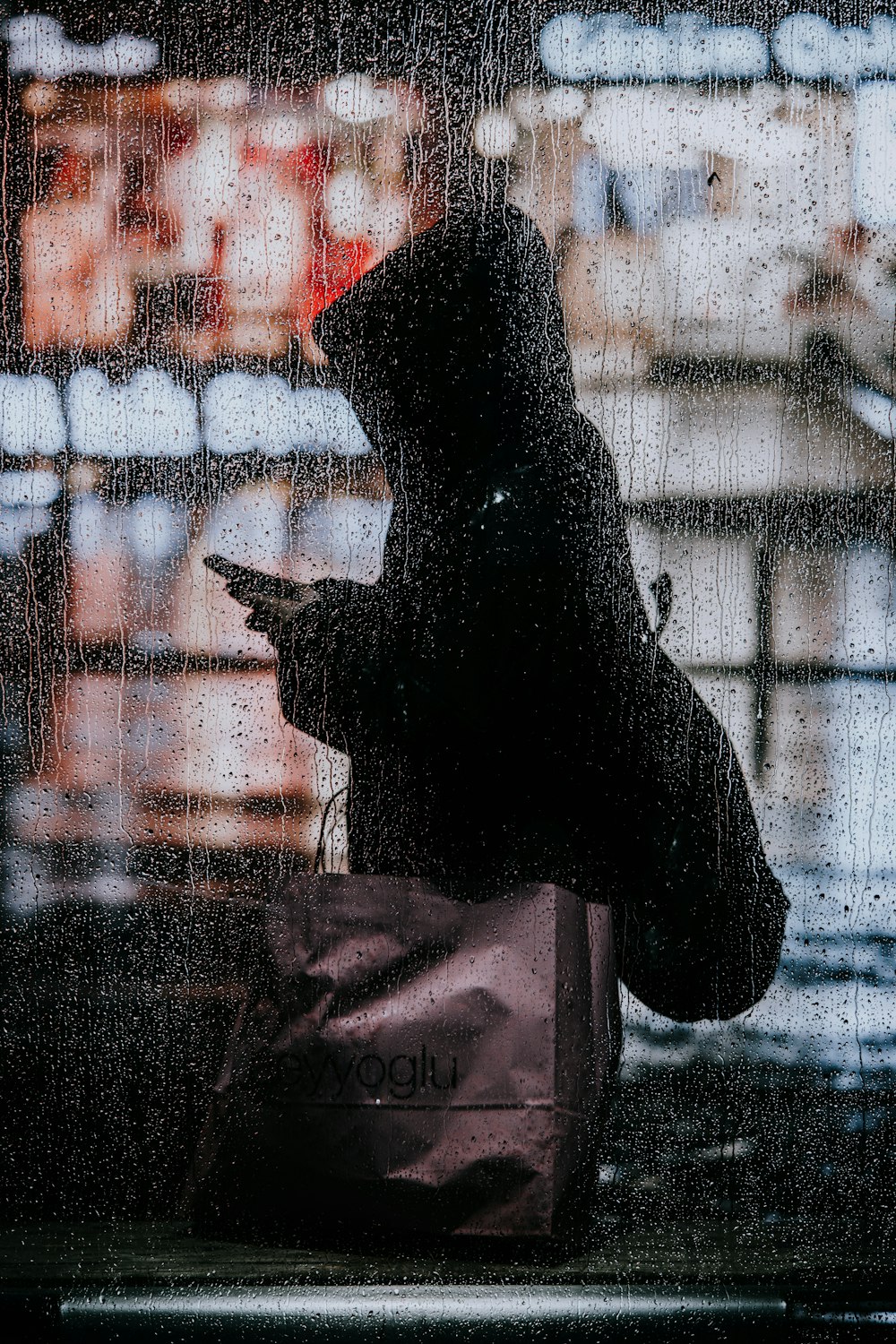 silhouette of person in front of glass window