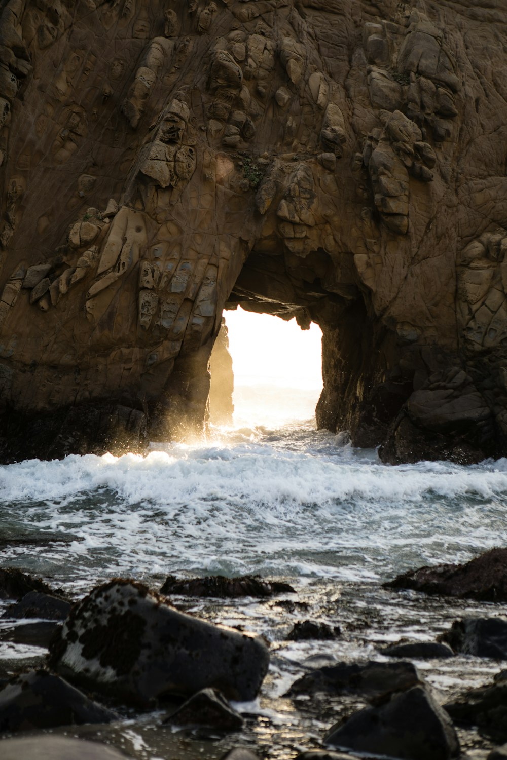 brown rock formation near body of water during daytime