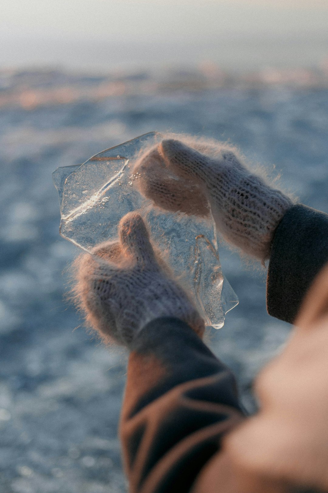 person in gray gloves holding clear plastic bag