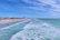 A scenic view of Daytona Beach with people enjoying the sun and surf.