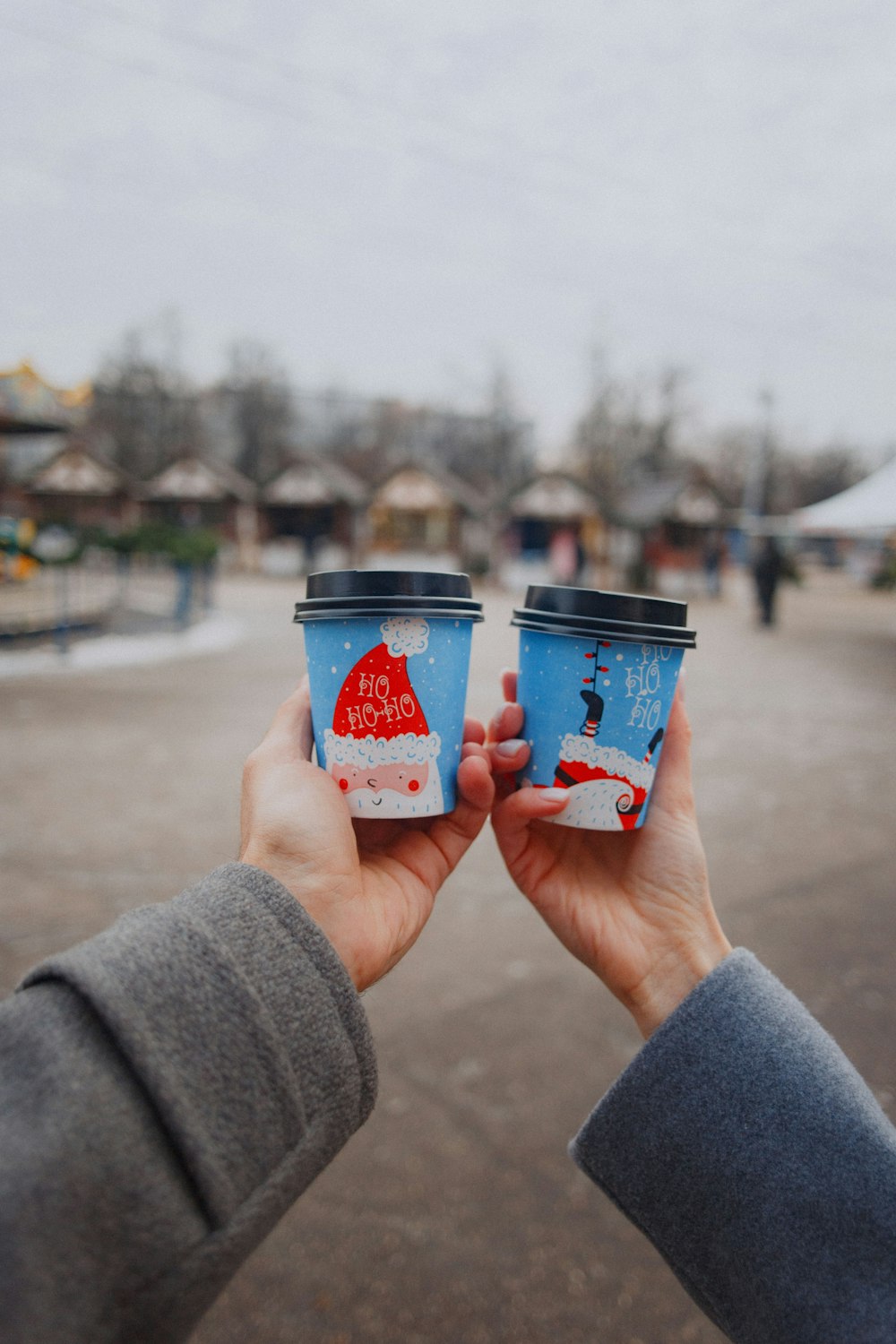 person holding red and white plastic cup