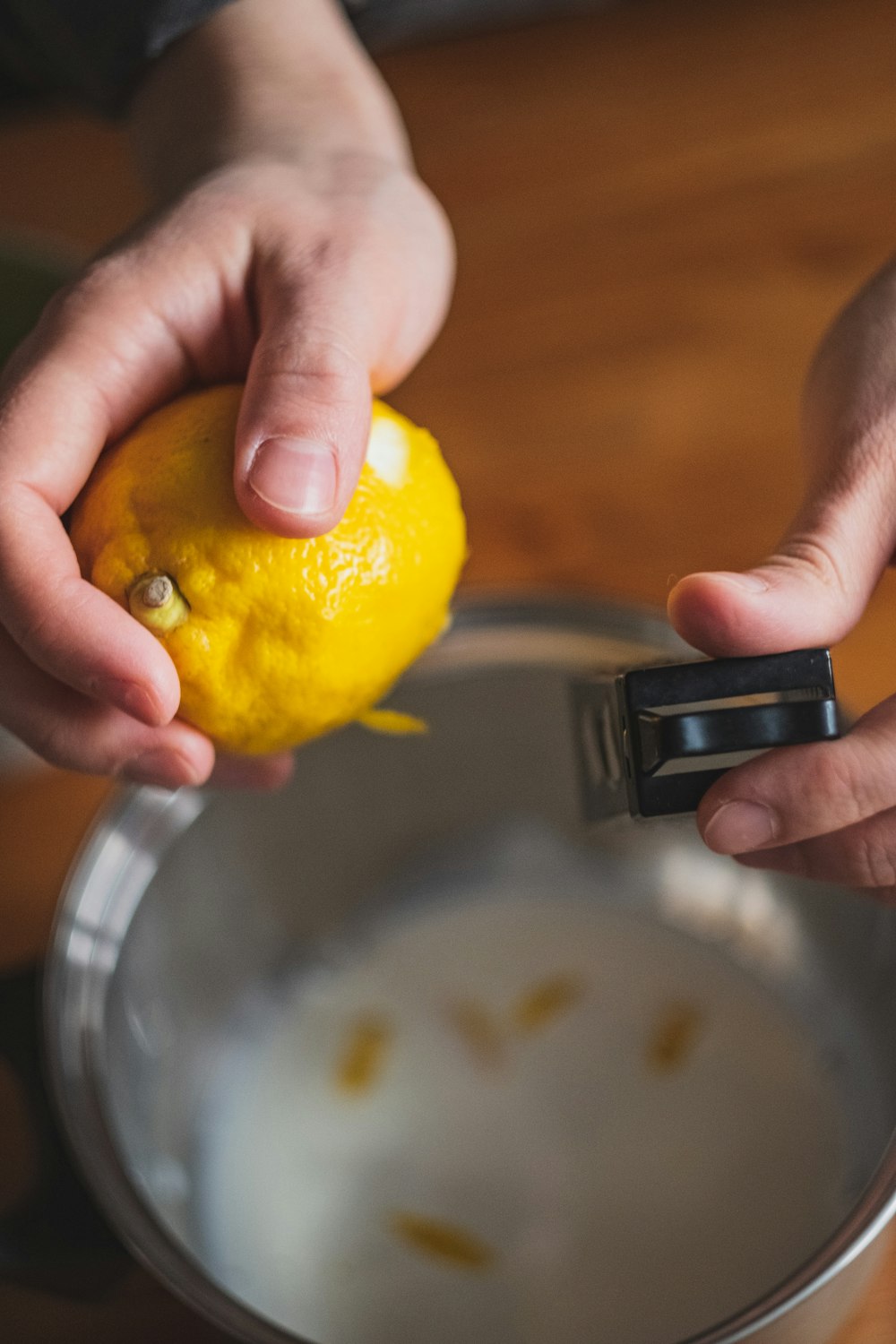 person holding yellow lemon fruit