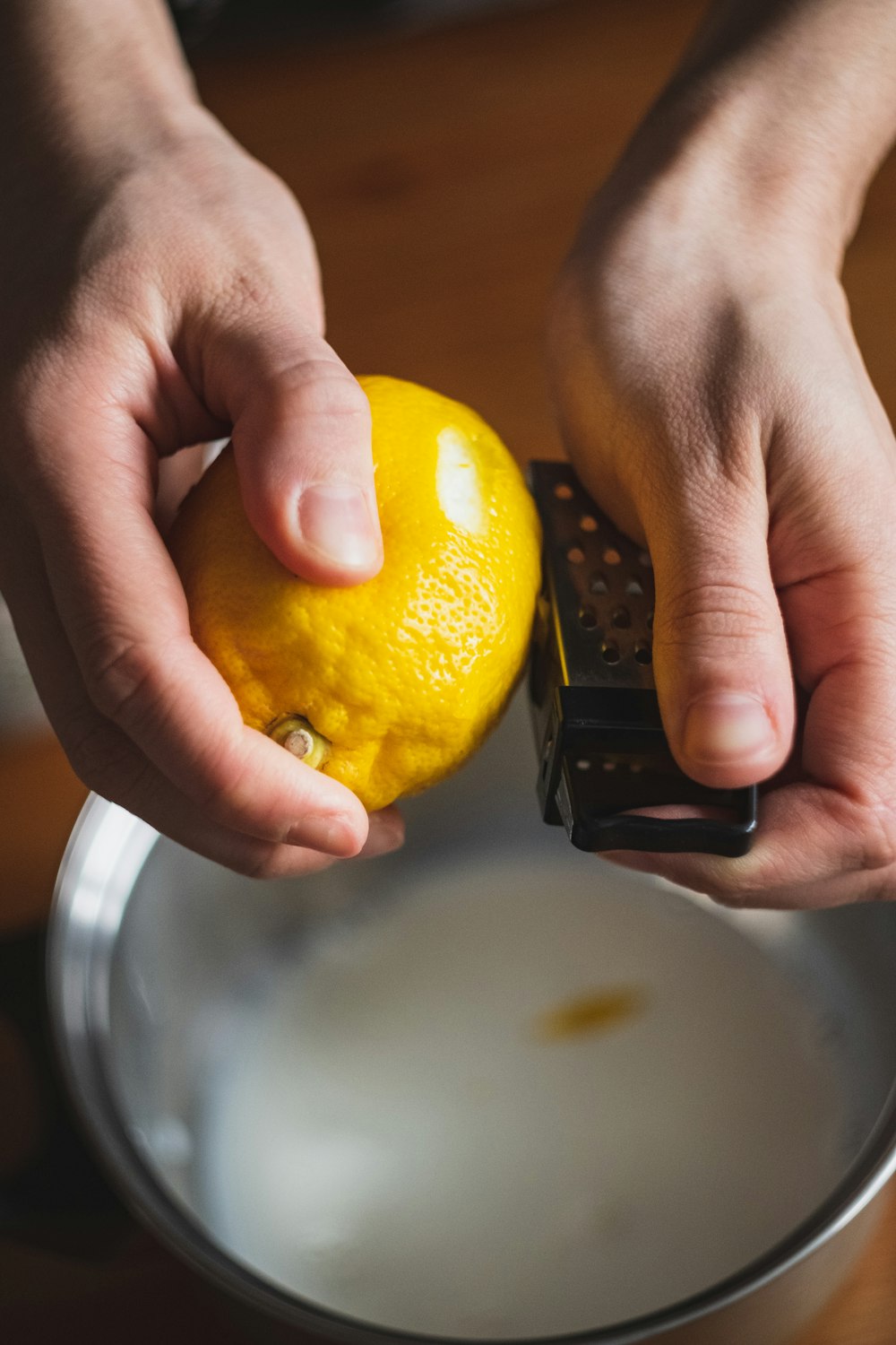 person holding yellow citrus fruit