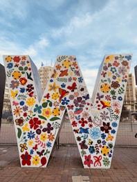 white blue and red floral textile on brown wooden fence