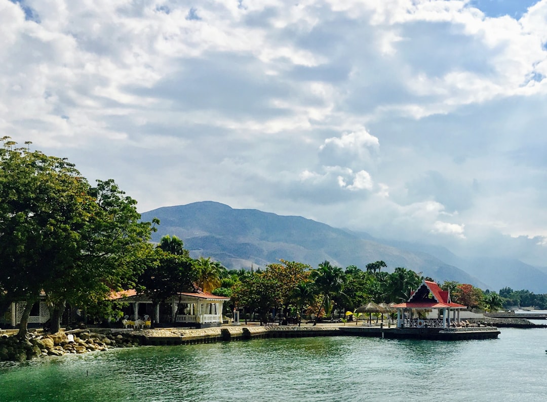 green trees near body of water under cloudy sky during daytime, Beautiful Haitian Beach