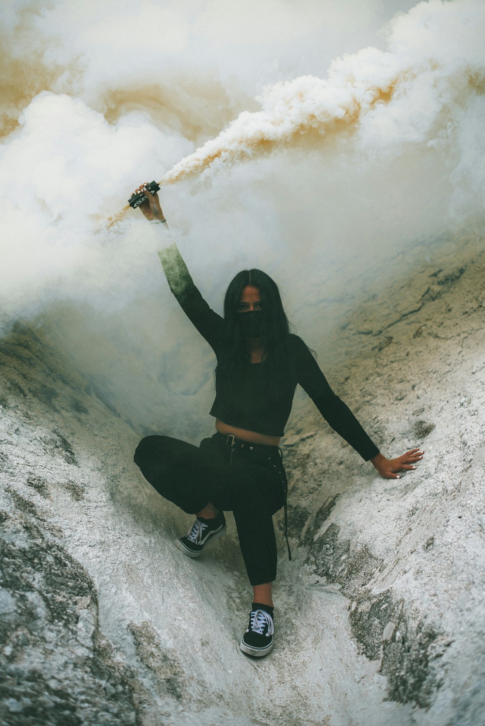 woman in black long sleeve shirt and black pants standing on snow covered ground