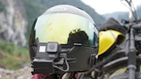 Close-up of an action camera mounted on a helmet during an adventurous city bike ride.