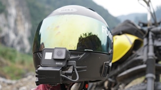 Motorcycle helmet worn by a rider on a highway, showing the mount holding an action camera steadily in place.