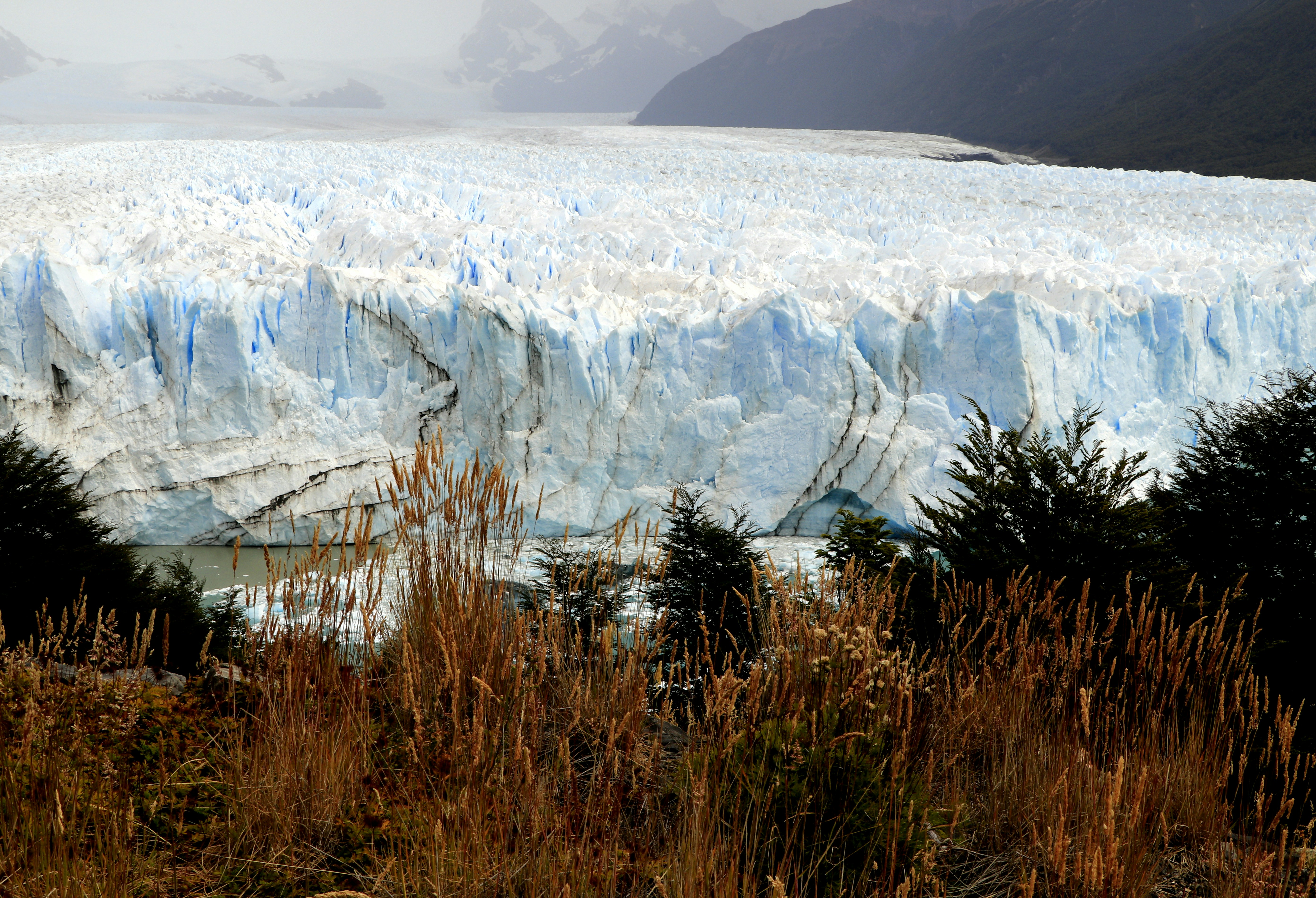 brown grass near white and blue mountain during daytime