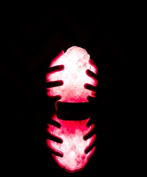 A pair of hands gently holding a glowing, translucent map of memories and emotions.